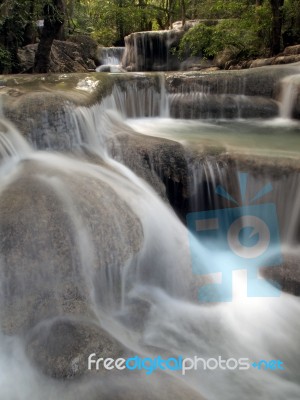 Waterfall With Water Flowing Around Stock Photo