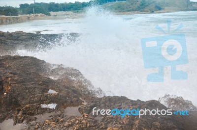 Waves Crashing On A Rock Stock Photo