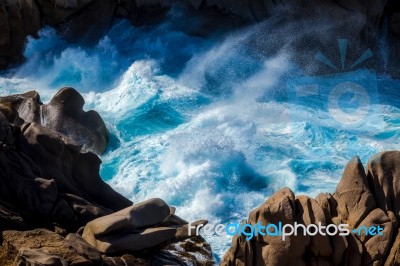 Waves Pounding The Coastline At Capo Testa Stock Photo