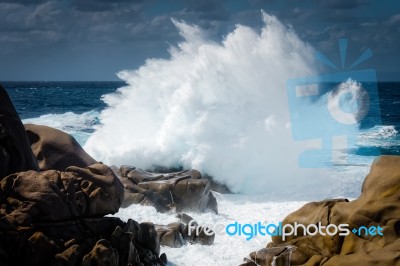 Waves Pounding The Coastline At Capo Testa Stock Photo