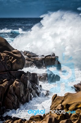 Waves Pounding The Coastline At Capo Testa Stock Photo