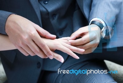 Wedding Ring Put On The Bride's Finger Stock Photo