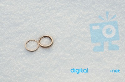 Wedding Rings In The Snow Stock Photo