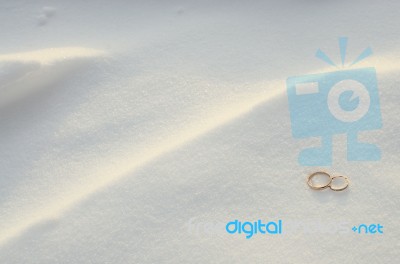 Wedding Rings In The Snow Stock Photo