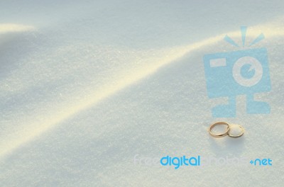 Wedding Rings In The Snow Stock Photo