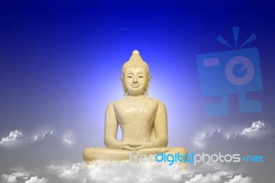 White Buddha Seated On Sky Stock Photo