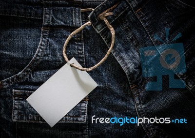 White Card On Wrinkled Jeans Stock Photo