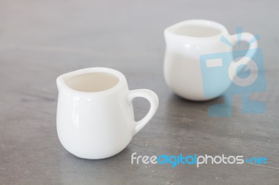 White Ceramic Pitcher On Grey Background Stock Photo