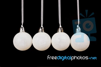 White Christmas Balls Hanging In A Row On Black Background Stock Photo