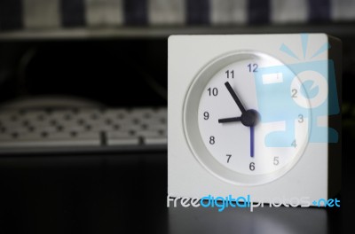 White Clock, On Business Table In The Office Stock Photo