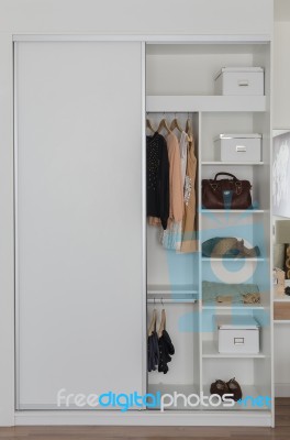 White Closet With Clothes And Accessories Stock Photo