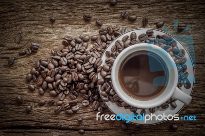 White Coffee Cup And Coffee Beans On Old Wooden Background. Top View  Stock Photo