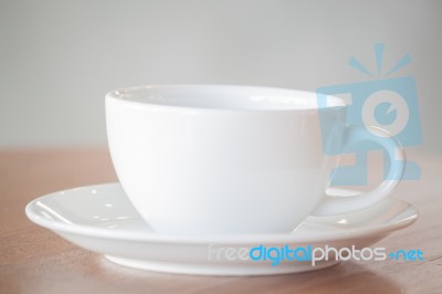 White Coffee Cup On Wooden Table Stock Photo