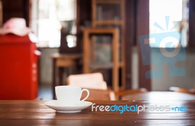 White Coffee Cup On Wooden Table Stock Photo