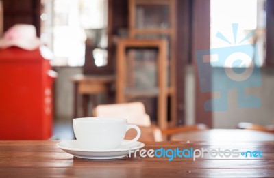 White Coffee Cup On Wooden Table Stock Photo