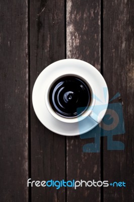 White Coffee Cup With Black Coffee On Wood Background Stock Photo