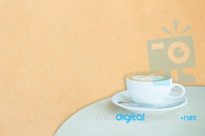 White Cup Of Coffee Latte On Brown Paper Backgound Stock Image