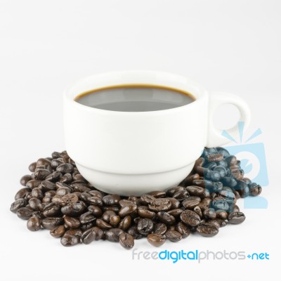 White Cup Of Coffee On Beans Stock Photo