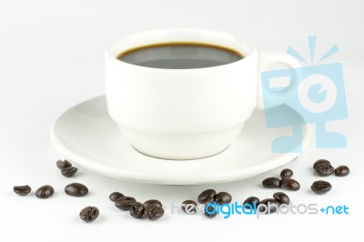 White Cup Of Coffee On Beans Stock Photo