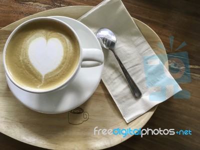 White Cup Of Heart Shape Cappuccino Coffee On Wood Plate Stock Photo