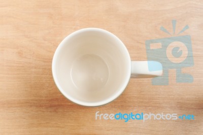 White Cup Top View On Wooden Table Stock Photo