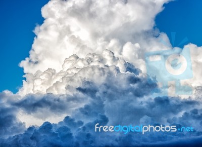 White Dense Clouds In The Bright Blue Sky Stock Photo