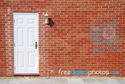 White Door On A Brick Wall Stock Photo