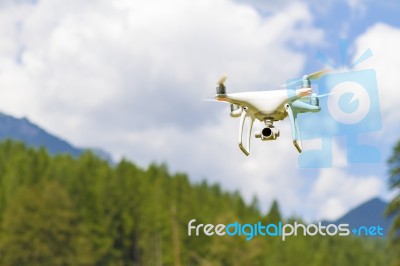 White Drone Flying Above Mountains Stock Photo