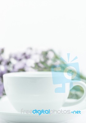 White Mug Cup And Static Flower Stock Photo