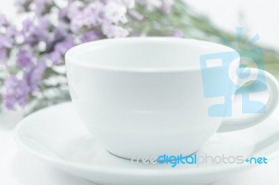 White Mug Cup And Static Flower Stock Photo