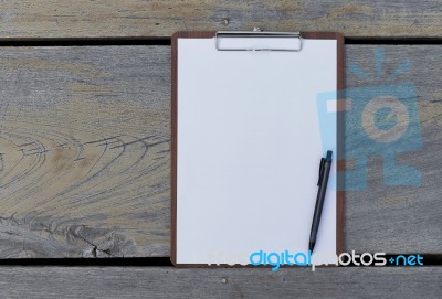 White Paper On Wood Background Stock Photo