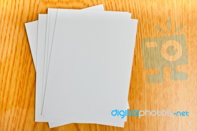 White Paper On Wood Table Stock Photo