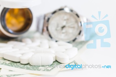 White Pills And Money On White Background Stock Photo