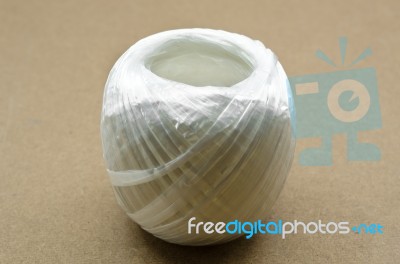 White Plastic Rope On Brown Background Stock Photo