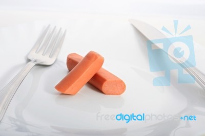 White Plate With Sausage Over White Table Stock Photo