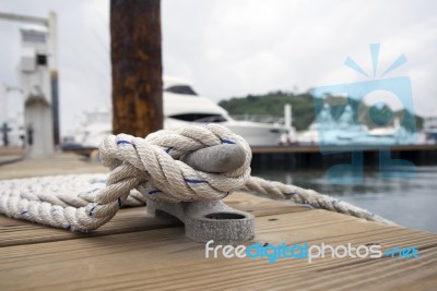 White Rope With Mooring Bollard Stock Photo