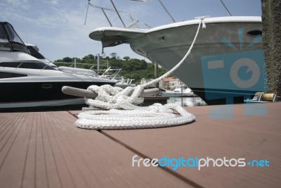 White Rope With Mooring Bollard Stock Photo