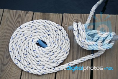 White Rope With Mooring Bollard Stock Photo