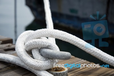 White Rope With Mooring Bollard Stock Photo