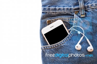 White Smartphone In Your Pocket Blue Jeans With Earphone And Usb Cable For Transfer Data Or Information On Isolated Background Stock Photo