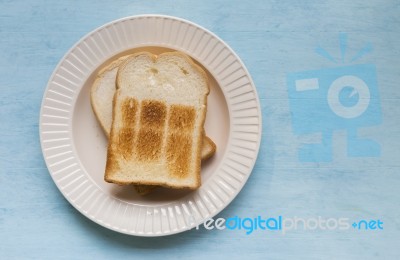 White Toast On Blue Table Background Stock Photo