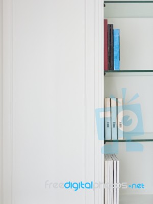 White Traditional Style Wood Cabinet With Book And Glass Shelf Stock Photo