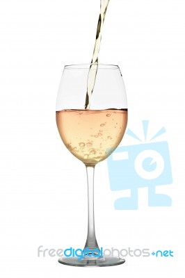 White Wine Flowing Into A Glass Isolated On White Stock Photo