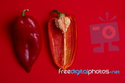 whole and halved Red Peppers Stock Photo