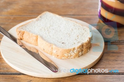 Whole Grain Bread On Wooden Plate Stock Photo