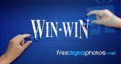 Win Win Word On Jigsaw Puzzle. Man Hand Holding A Blue Puzzle To… Stock Photo