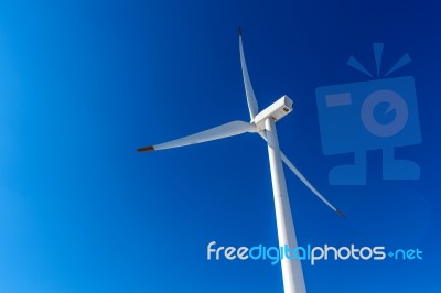 Wind Turbine And Blue Sky In Winter Landscape Stock Photo