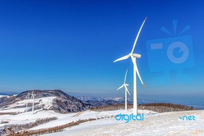 Wind Turbine And Blue Sky In Winter Landscape Stock Photo