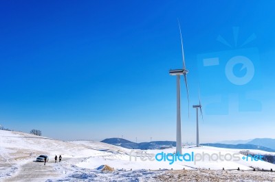 Wind Turbine And Blue Sky In Winter Landscape Stock Photo