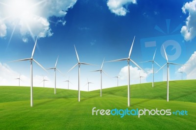 Wind Turbine On Green Grass Field Stock Photo